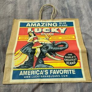 Vintage Lucky Brand Jeans brown paper shopping bag.  Circus themed. Used.